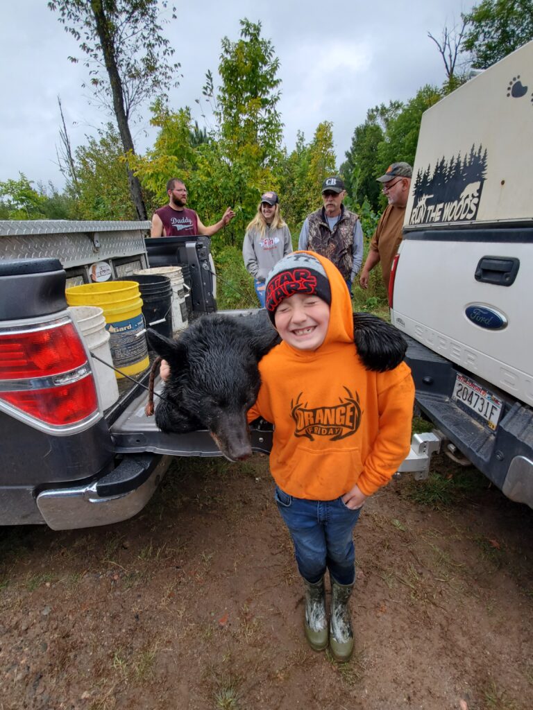 October 2021 | SJ Monacelli | A boy & his bear | This is my first bear. I'm 7 years old and harvested the bear in the 2021 season hunting with hounds.